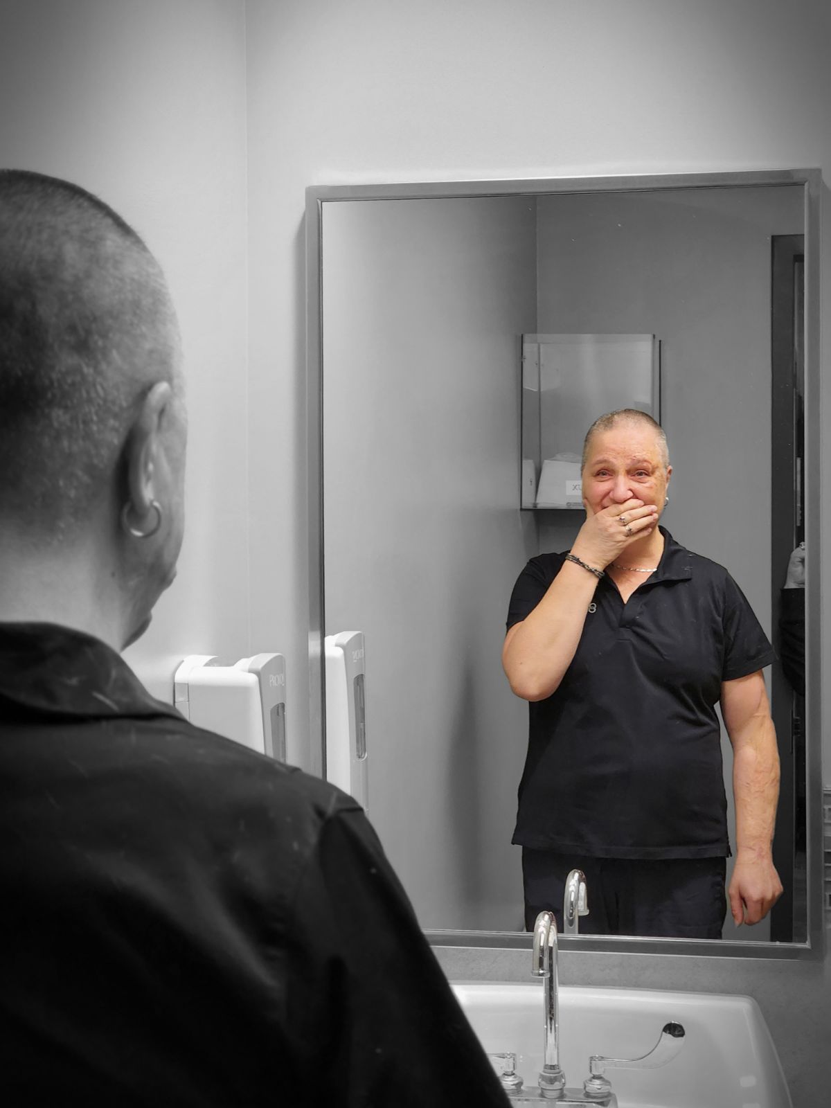 Caregiver looks at shaved head