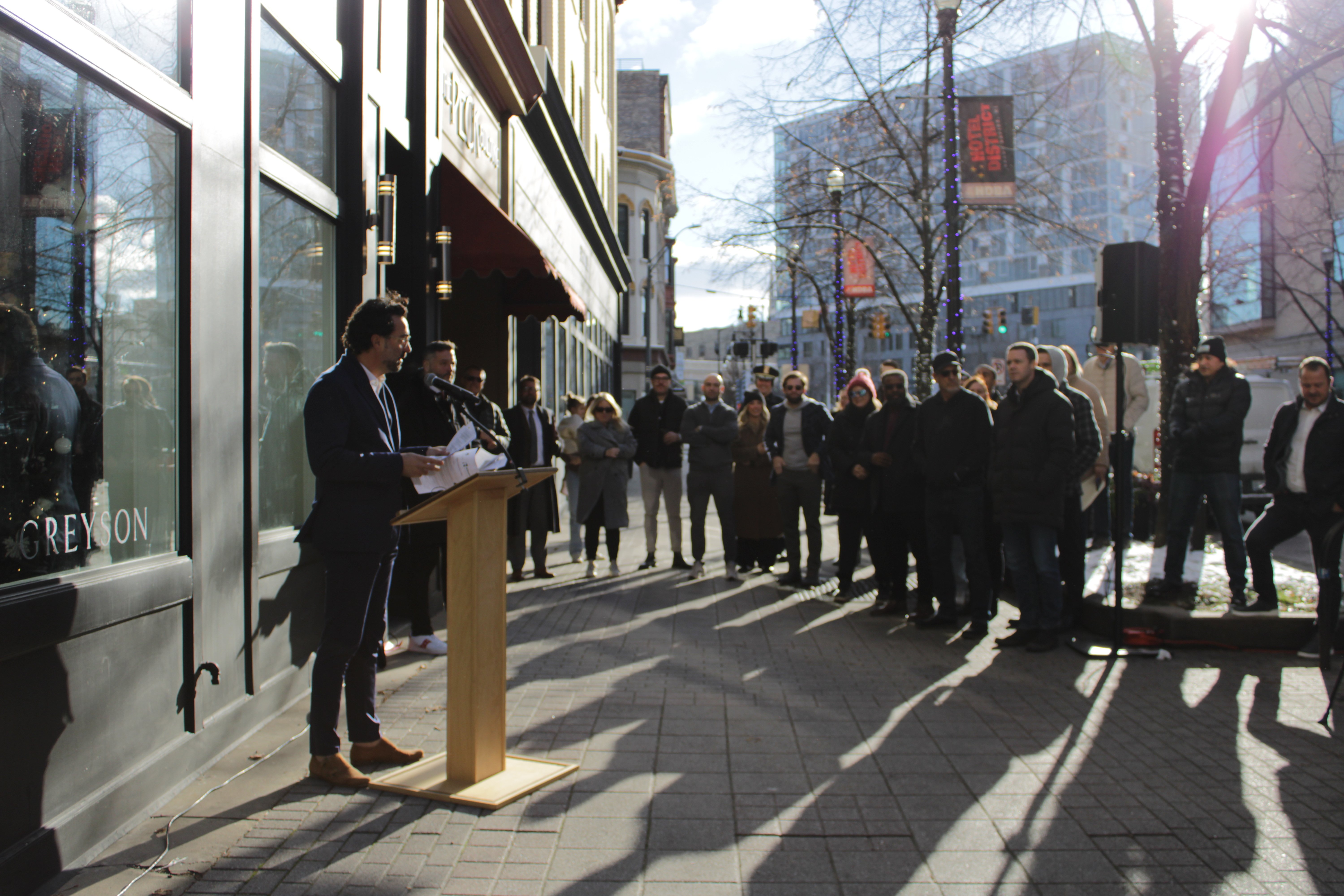 Chris Brancato, Greyson VP Retail speaking at ribbon cutting