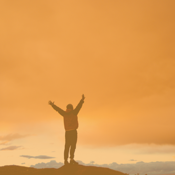 A person who just climbed a mountain, both inspiring and motivational