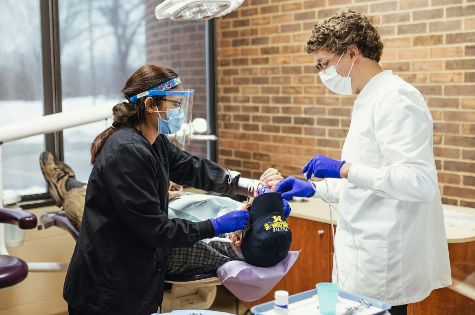 Dental hygienists clean teeth at MCDC